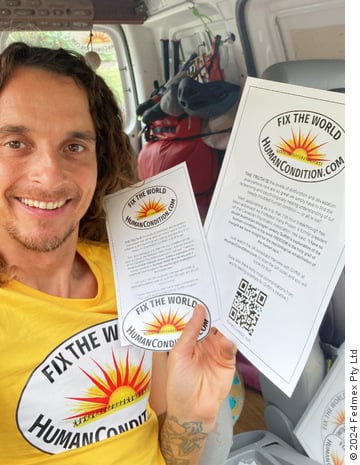 Ales Flisar holding ‘Fix The World’ flyers, wearing a ‘Fix The World’ t-shirt