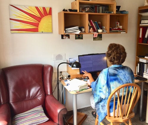 Annemieke Akker working on her computer translating the Freedom Essays