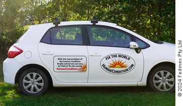 A car with a decal sticker on the side door promoting HumanCondition.com