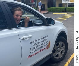 Tony Gowing in car with 'Actually save the world' sticker