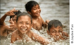 Image of children playing happily in water