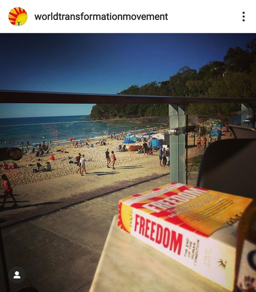 Instagram post of the book FREEDOM in the Noosa Surfclub with people on the beach in the background