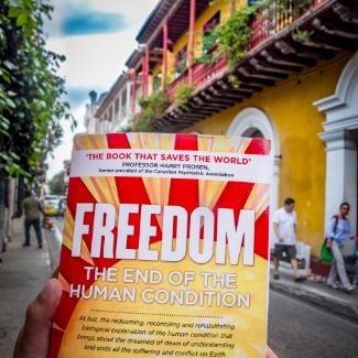 FREEDOM book in colourful Colombian street - World Transformation Movement Commendations