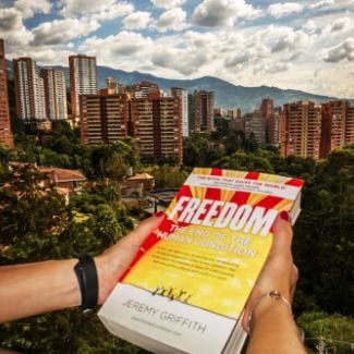 FREEDOM book with Bogata city in the background - World Transformation Movement Commendations