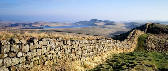 The substantial man-made rock wall construction that runs across the landscape that is Hadrian’s Wall in northern England.