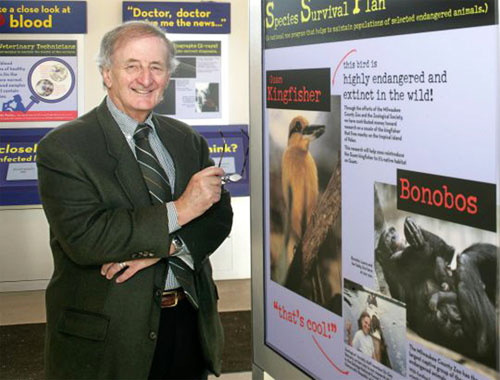 Prof. Harry Prosen standing in front of bonobo poster at a Primate Conference - World Transformation Movement image