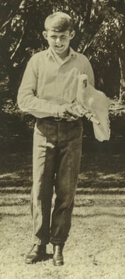 Jeremy Griffith aged 13 holding his pet cockatoo