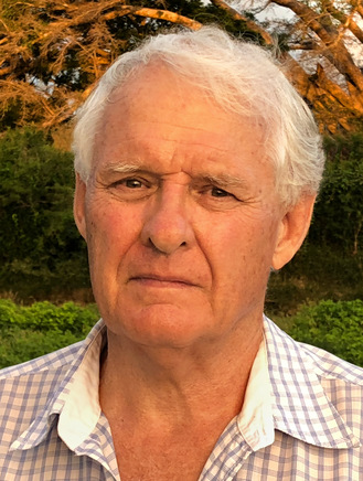 Portrait photograph of Jeremy Griffith, in 2018 aged 72, in front of a banyan tree