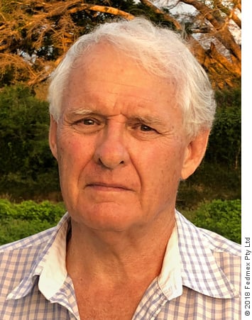Portrait photograph of Jeremy Griffith, in 2018 aged 72, in front of a banyan tree