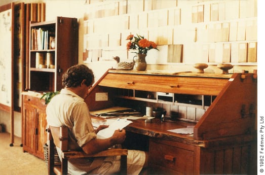 Jeremy Griffith working at his desk in the Griffith Tablecraft Murwillumbah showroom