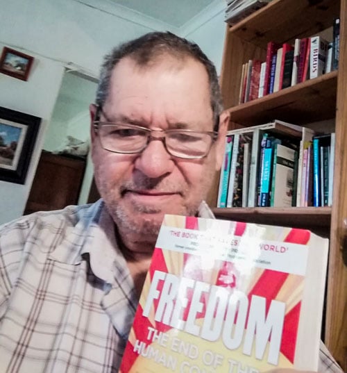 John Mulder holding the book FREEDOM: The End of the Human Condition by Jeremy Griffith