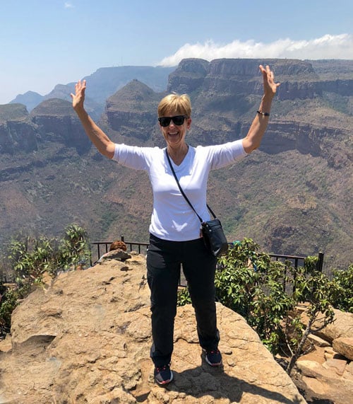 Karen Riley with arms outstretched in the Grand Canyon, South Africa