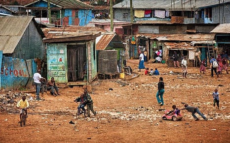 Shanty town and children playing on dirt