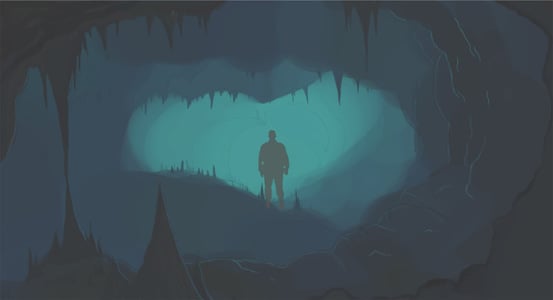 Silhouette of man in dark cave