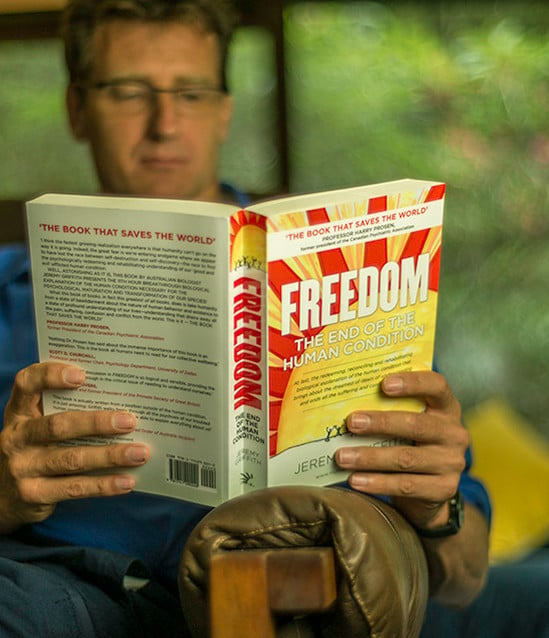 Man reading the book FREEDOM available from the World Transformation Movement