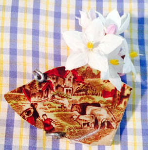 Pottery brooch by Jeremy Griffith with illustration of an English pastoral scene
