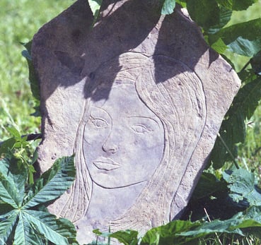 Stone carving of a girl's face by Jeremy Grifith