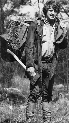 Jeremy carrying his tiger trap in Tasmania between 1967 and 1972