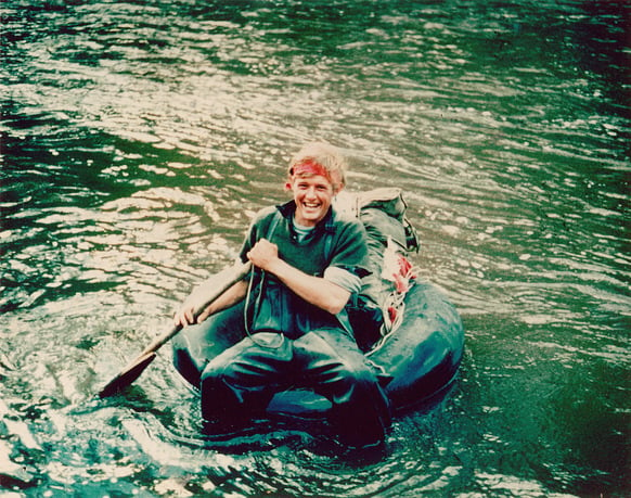Jeremy Griffith on a tractor tyre tube on the Arthur River during his search for the Tasmanian Tiger between 1967-1974.