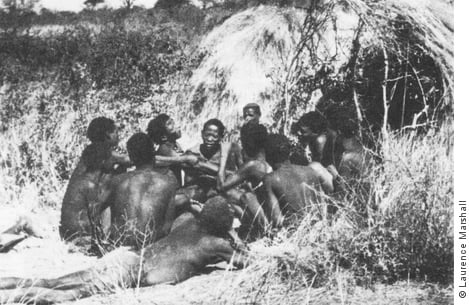 Bushmen men in a group ‘telling the hunt’