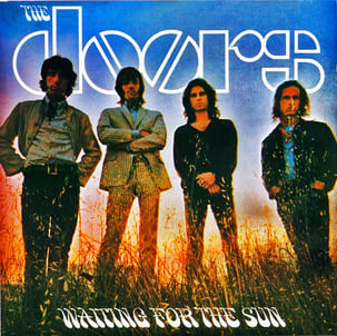 The record album cover title ‘The Doors’ ‘Waiting for the Sun’ with the band in front of a sunlit dawn