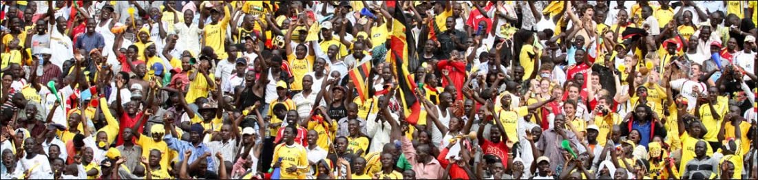Cheering crowd dressed in Ugandan colours