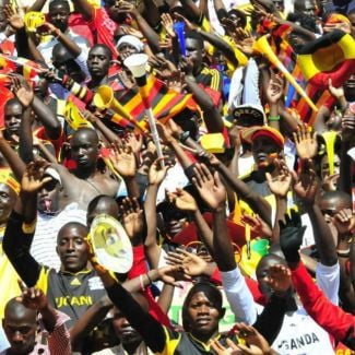 Crowd wearing Uganda colours cheering