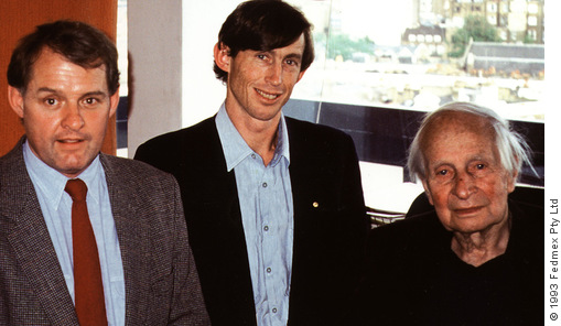 Jeremy Griffith and Tim Macartney-Snape, both standing, with Sir Laurens van der Post, seated, in his London office, 1993.