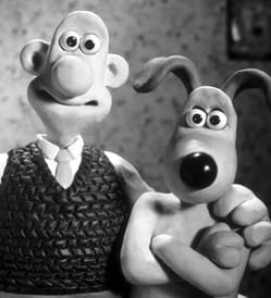 Portait of the animation characters, Wallace and his dog Gromit, that he has his arm around.