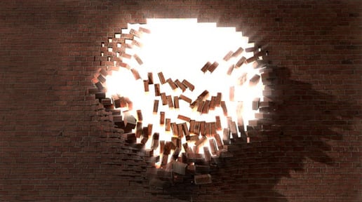 A hole in a wall with bricks falling away and sunlight pouring in