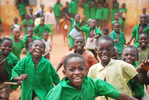 Happy school children laughing and running