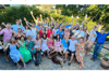 Group photo of people with their hands in the air