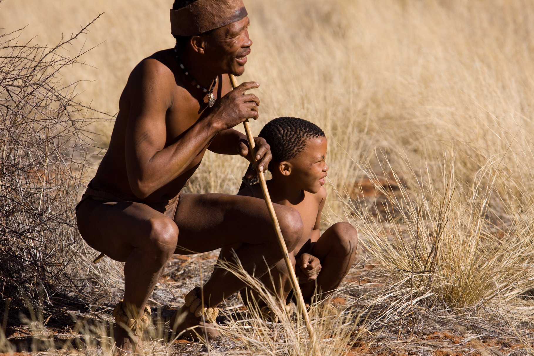 Bushman and child in desert