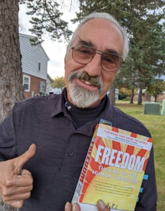 Bob Montefusco holding the book FREEDOM