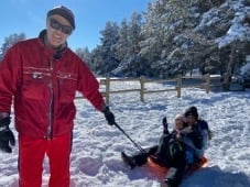 David pulling children on sled in snow
