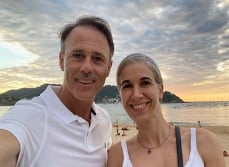 David with his wife on a beach with sunsetting