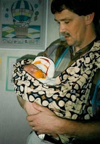 Hendrik Riksen holding his child