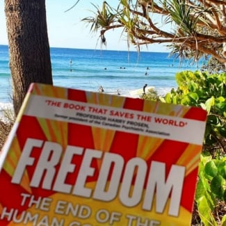 The book 'FREEDOM' at the beach